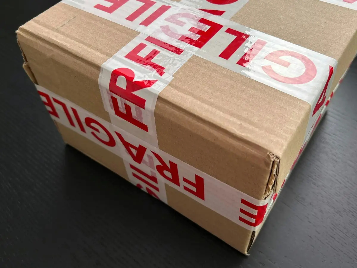 Cardboard parcel sealed with fragile tape