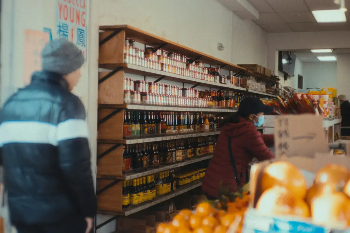 Shopper comparing products on a store shelf