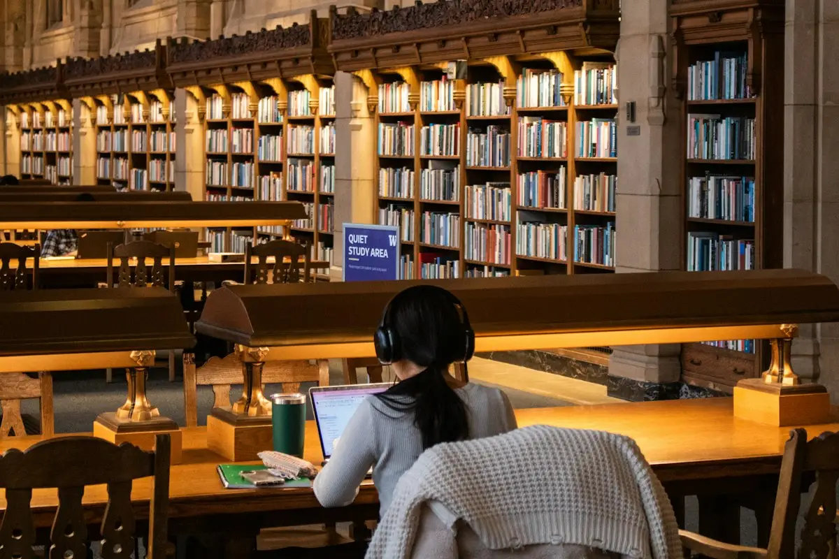 Student studying with books in a library
